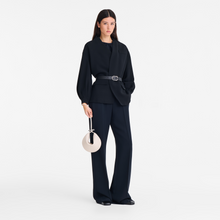 Load image into Gallery viewer, person holding Longchamp Le Roseau Leather Clutch in the color paper
