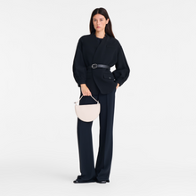 Load image into Gallery viewer, person holding a Longchamp Le Roseau Leather Clutch in the color paper
