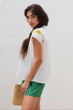 Load image into Gallery viewer, woman in the White Maya Embroidered Blouse side view showing drape of the fabric 
