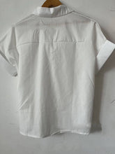 Load image into Gallery viewer, White Relaxed Short Sleeve Blouse on a hanger back view
