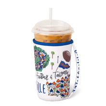 Load image into Gallery viewer, Swig Saturdays In Gainesville Iced Cup Coolie with handle and holding an iced coffee cup
