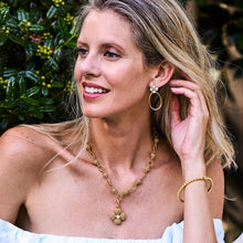 Load image into Gallery viewer, person wearing gold jewelry including the Capucine de Wulf Berry Clover Teardrop Earrings
