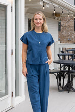 Load image into Gallery viewer, woman in the Hayley Linen Pants in blue paired with a matching top
