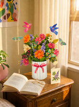 Load image into Gallery viewer, FreshCut Paper Enchanted Garden oon a bed side table 
