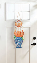 Load image into Gallery viewer, Pumpkin Topiary Door Hanger on a door
