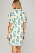 Load image into Gallery viewer, back view cream dress with blue flower print with short sleeve blue striped accents along the sleeves and hem
