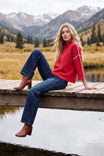 Load image into Gallery viewer, woman wearing a Mock Neck Christmas Sweater  and jeans on a dock
