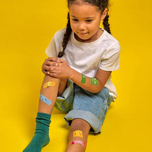 Load image into Gallery viewer, kid with several Kidoki OuchyFriend Adhesive Bandage
