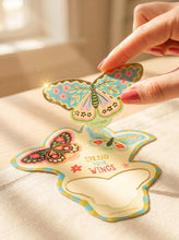 Load image into Gallery viewer, person holding a butterfly that comes with the FreshCut Paper Enchanted Garden
