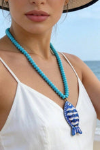 Load image into Gallery viewer, person wearing the light blue Vibrant Fish Pendant Beaded Necklace
