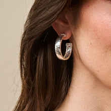 Load image into Gallery viewer, close up of a person wearing a Capucine de Wulf Jewelry Cleopatra Classic Hoop Earrings in silver
