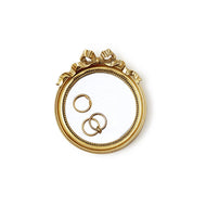 Round Mirror Trinket Tray with Accent Bow with three rings sitting on the glass