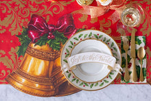 Load image into Gallery viewer,  red paper with gold Damask pattern  set with a place setting 
