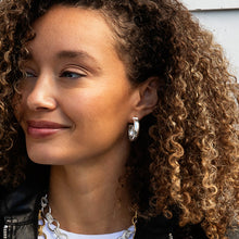 Load image into Gallery viewer, close up of a person wearing a Capucine de Wulf Jewelry Cleopatra Classic Hoop Earrings in silver
