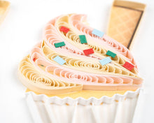 Load image into Gallery viewer, Close up of quilled cupcake frosting in cream and like pink with sprinkles 
