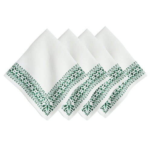 four white napkins with green floral border