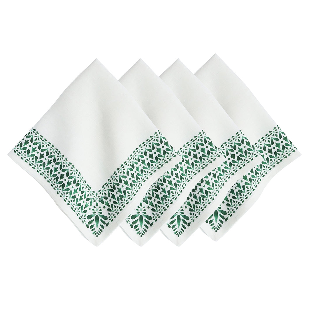 four white napkins with green floral border