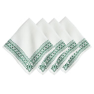 four white napkins with green floral border