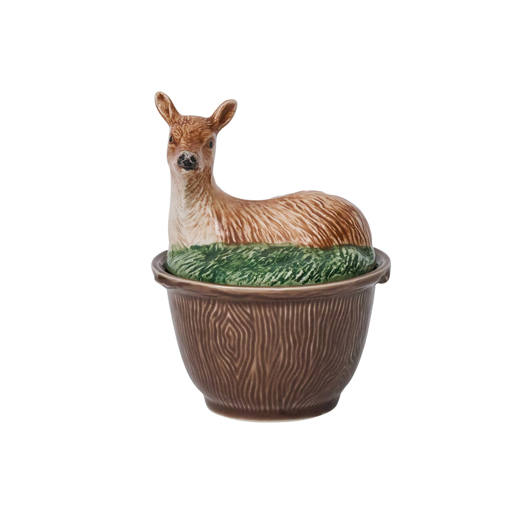 Brown bowl with a woodgrain texture and a lid shaped like a deer sitting in the grass
