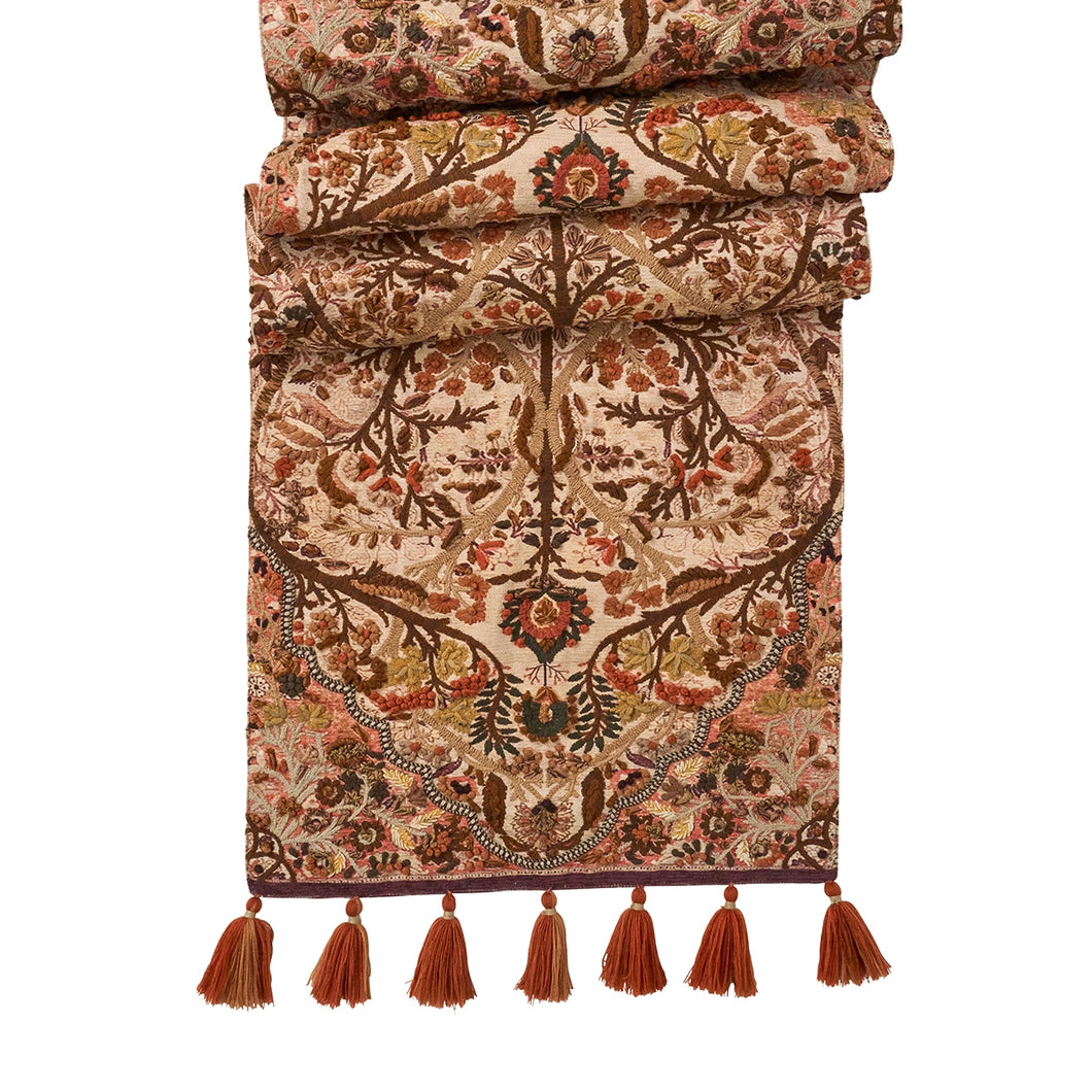 Table runner in earth tones with a heavy floral pattern 