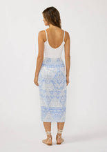 Load image into Gallery viewer, person wearing a blue and white wrap skirt paired with a white tank top and white sandals back view
