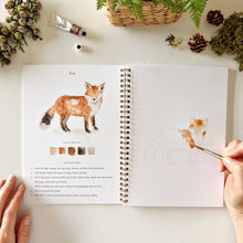 Load image into Gallery viewer, Woodland Watercolor Workbook with person painting a fox
