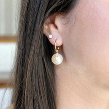 Load image into Gallery viewer, person wearing gold pearl earrings
