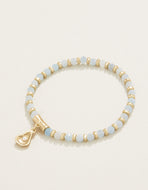 white and sea foam blue stone interspersed with gold beads with a single oyster and pearl  charm