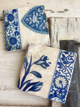 Load image into Gallery viewer, two coasters with blue and cream floral designs
