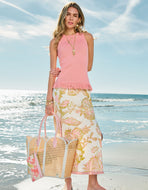 person wearing Spartina 449 Jersey Midi Skirt Castillo Jacobean Cream holding a bag while at the beach