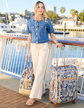 Load image into Gallery viewer, person on a dock wearing Murphy Denim Jacket May River Wash paired with light colored pants
