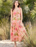 woman in pink floral pint dress with green trim and button up front