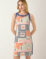 woman in mid length sleeveless dress with fish. sailboat, and stripes pattern in orange light blue pink and navy pattern