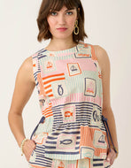 person wearing the Spartina 449 Nadia Sleeveless Blouse Admiral pattern. Sleeveless blouse with gathered waist and a pink, light blue, orange and navy nautical and stripe patter