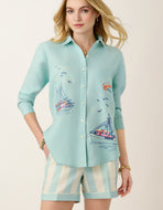 woman in blue button but 3/4 sleeves embroidered with boats
