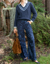 Load image into Gallery viewer, woman in Spartina 449 Cadence Denim Trouser Japonica Floral Denim paired with a blue v-neck sweater 
