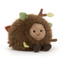 Load image into Gallery viewer, round plush with brown fur with green leaves and brown branches, at the center is a light tan face with a smile
