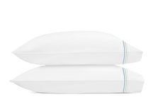 Load image into Gallery viewer, Two pillows with Amara Triple Pearl pillowcases with three lines of embroidery in three pool blue shades
