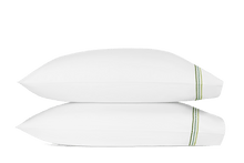 Load image into Gallery viewer, Two pillows with Amara Triple Pearl pillowcases with three lines of embroidery in three green shades
