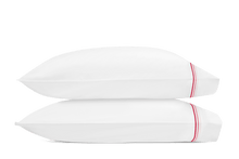 Load image into Gallery viewer, Two pillows with Amara Triple Pearl pillowcases with three lines of embroidery in red and pink shades
