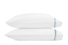 Load image into Gallery viewer, Two pillows with Amara Triple Pearl pillowcases with three lines of embroidery in three sailor blue shades
