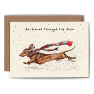 Greeting card with an image of a dachshund dog with a scarf running through the snow text reads Dachshund through the snow