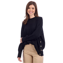 Load image into Gallery viewer, woman wearing a black sweater with long sleeves and button accents along the side
