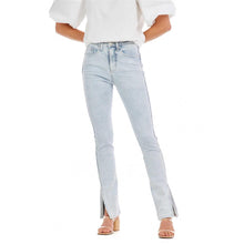 Load image into Gallery viewer, Woman in light blue jeans and a white shirt
