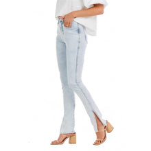 Load image into Gallery viewer, Woman in light blue jeans and a white shirt photographed from the side
