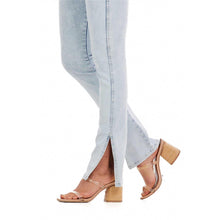 Load image into Gallery viewer, Woman in light blue jeans and a white shirt
