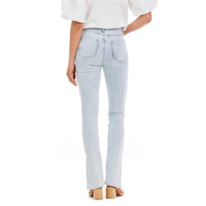 Woman in light blue jeans and a white shirt photographed from the back