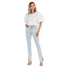 Load image into Gallery viewer, Woman in light blue jeans and a white shirt
