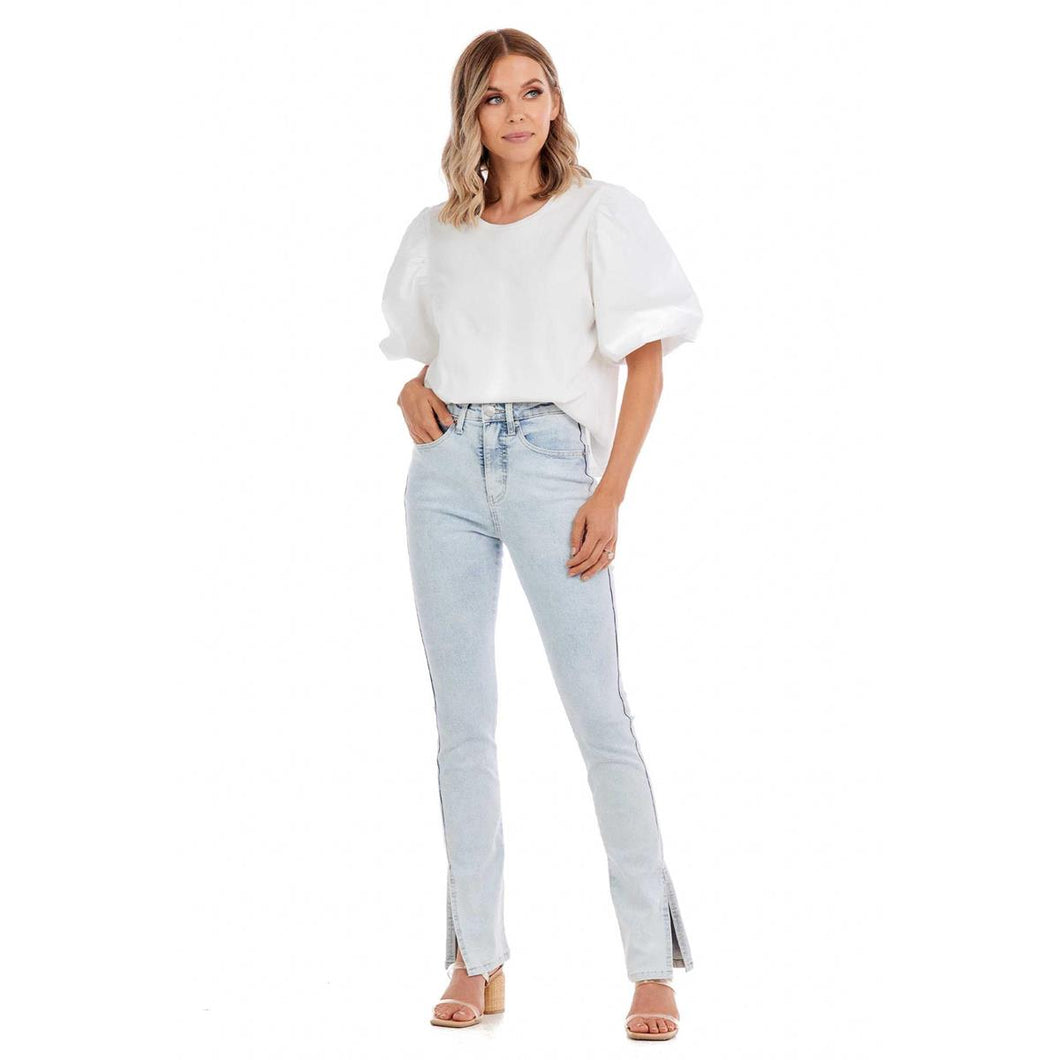 Woman in light blue jeans and a white shirt