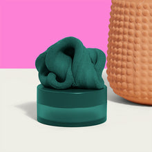 Load image into Gallery viewer, Speks Blur Calming Focus Putty in dark green sitting on a desk
